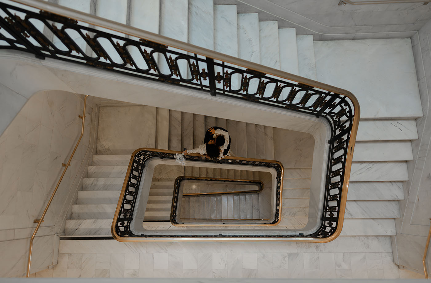 Overhead view of an elegant marble staircase captured in an editorial wedding photography style